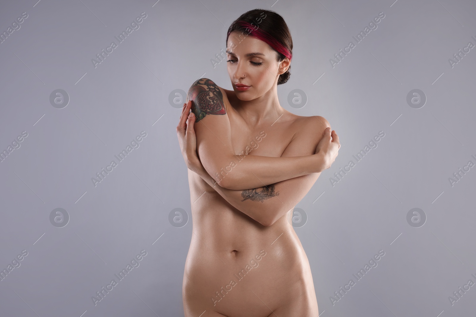 Photo of Beautiful nude woman on light grey background