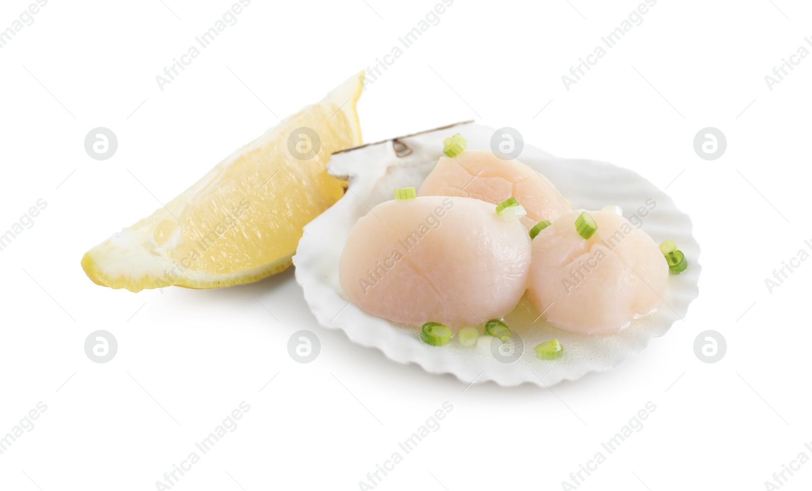 Photo of Raw scallops with green onion, shell and lemon slice isolated on white