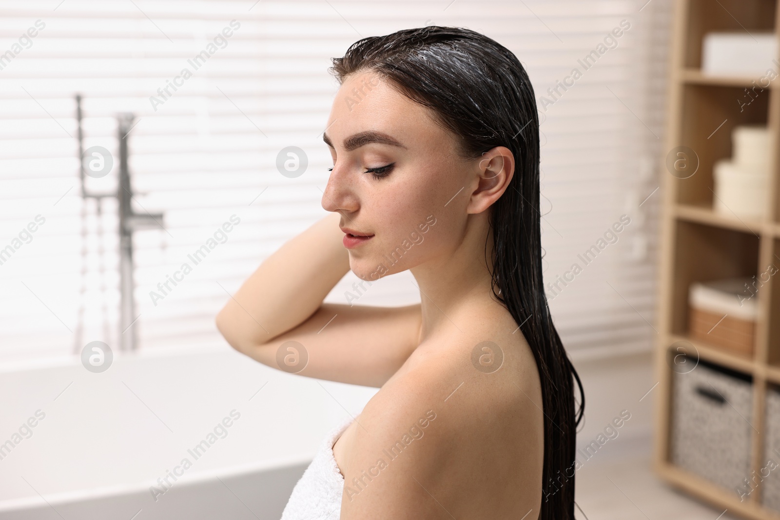 Photo of Beautiful woman with applied hair mask in bathroom