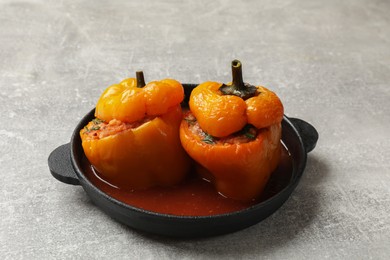 Photo of Tasty stuffed peppers on light grey table, closeup