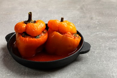 Photo of Tasty stuffed peppers on light grey table, closeup