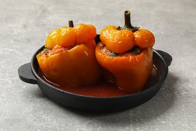 Photo of Tasty stuffed peppers on light grey table, closeup