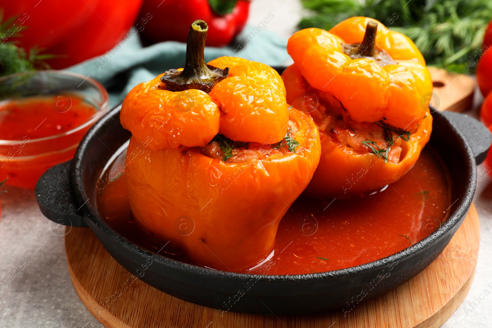 Photo of Tasty stuffed peppers on light grey table, closeup