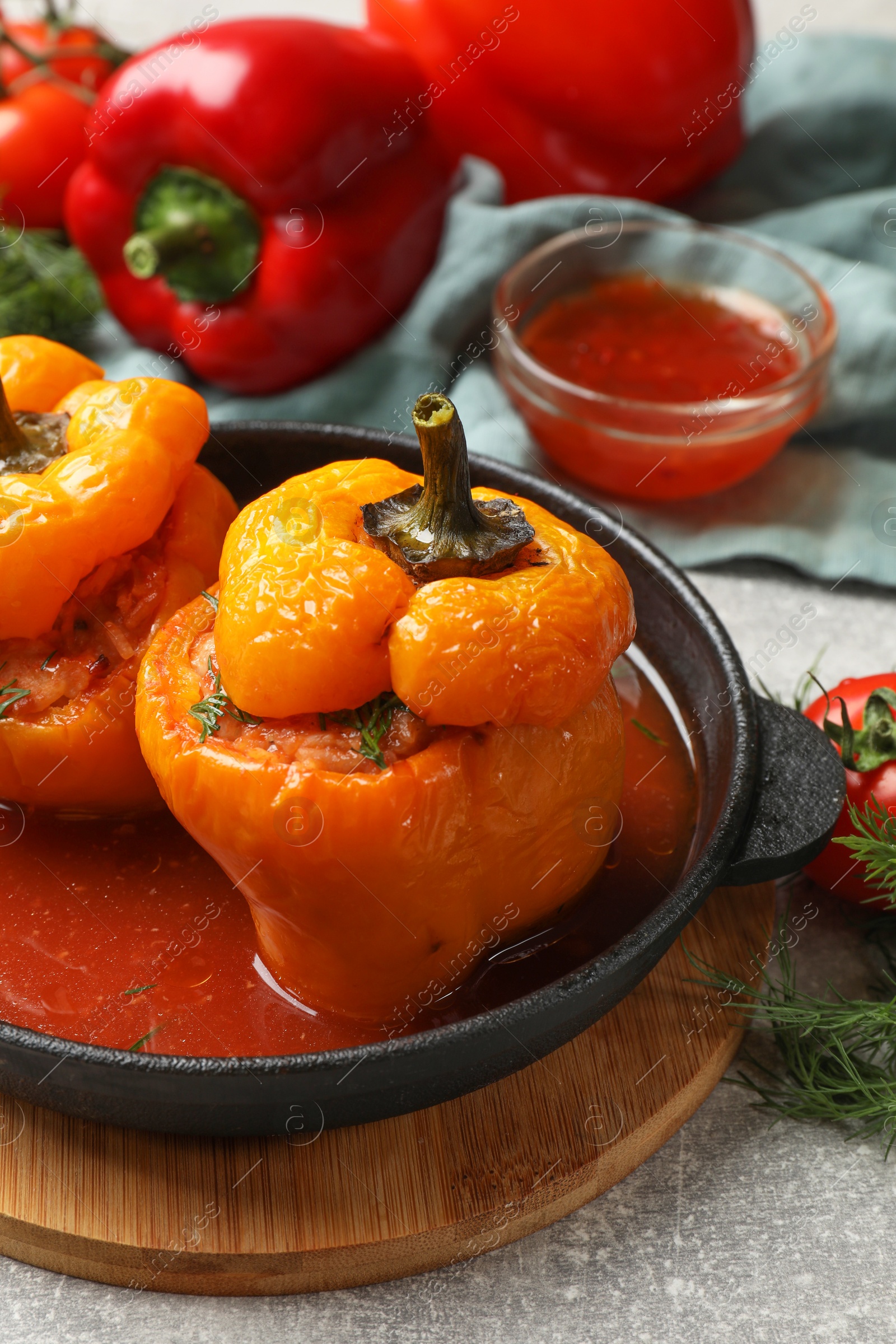 Photo of Tasty stuffed peppers on light grey table, closeup