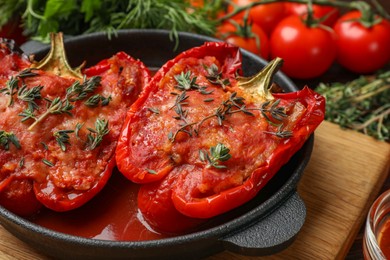 Photo of Tasty stuffed peppers in dish on table, closeup