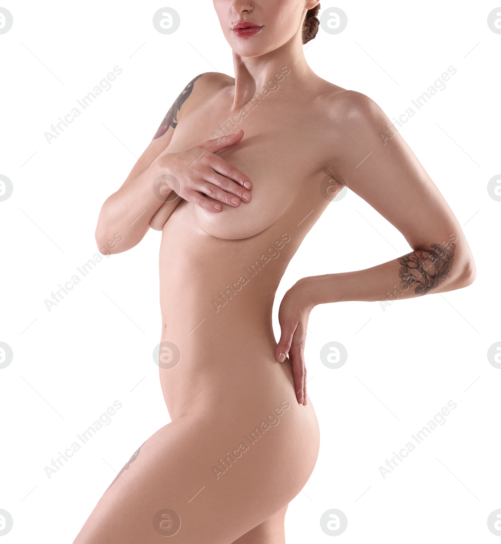 Photo of Nude woman with tattoos posing on white background, closeup