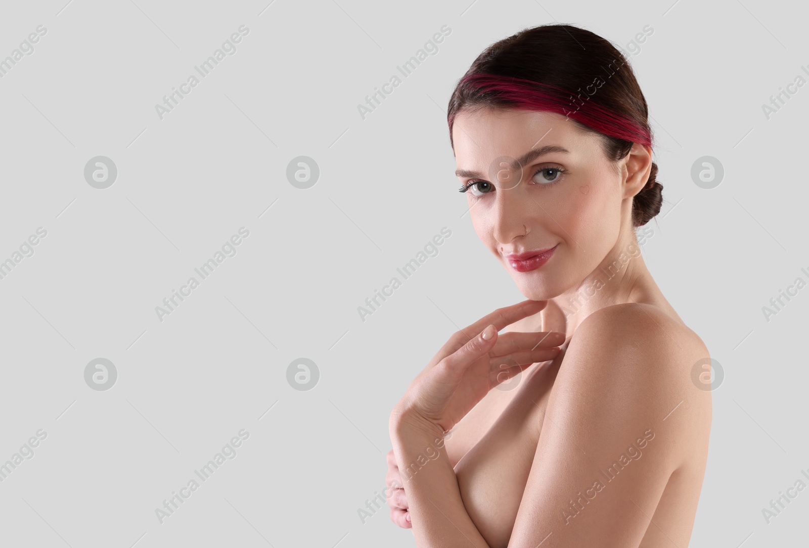 Photo of Beautiful nude woman posing on white background