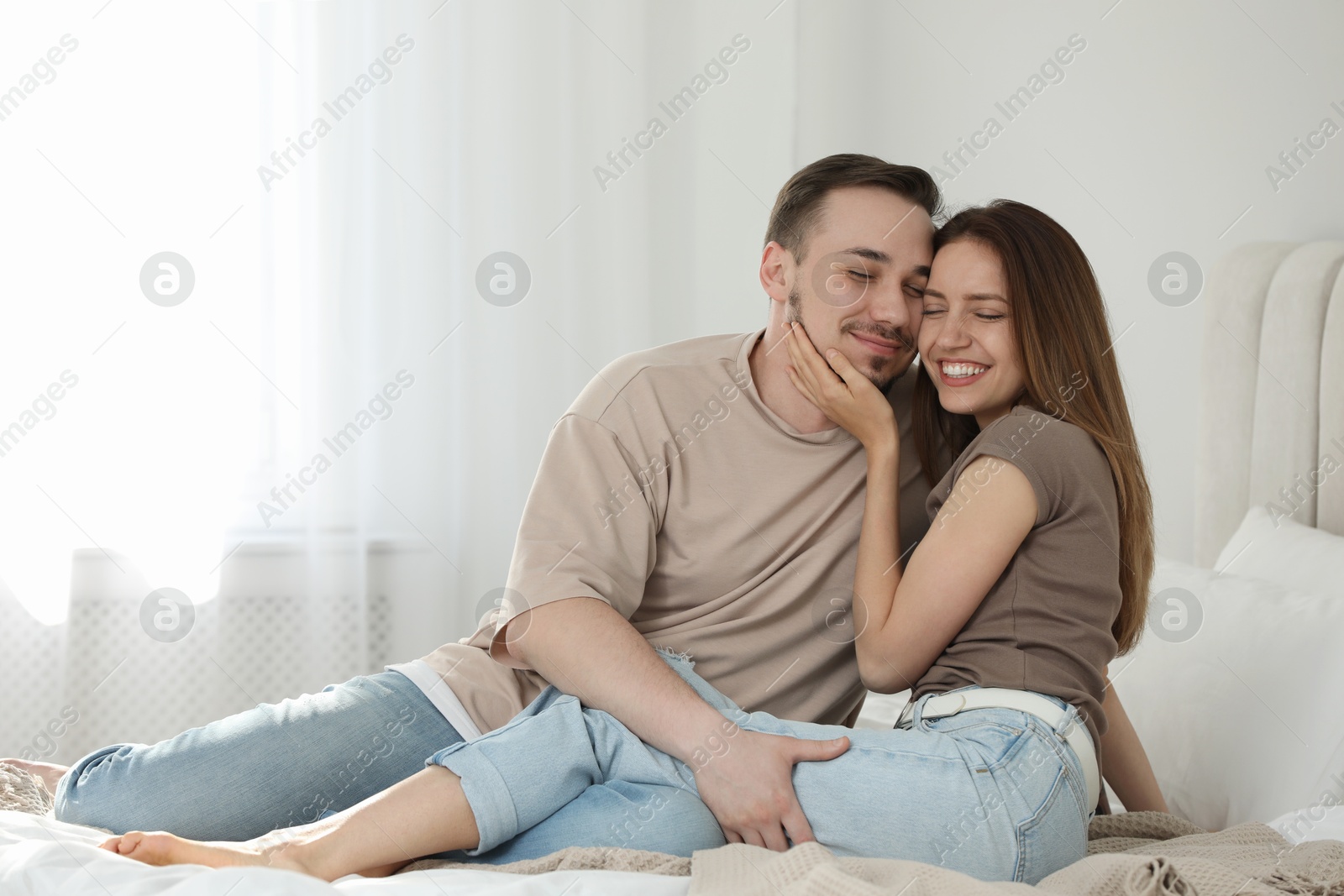 Photo of Lovely couple enjoying each other on bed at home