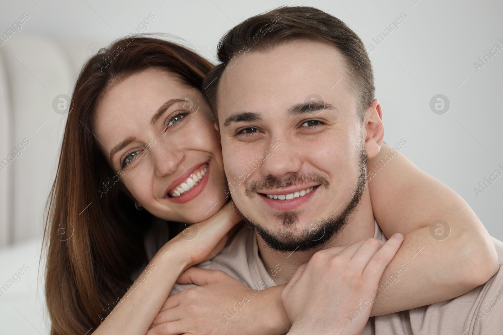 Photo of Portrait of happy couple hugging at home