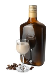 Coffee cream liqueur in bottle, glass and beans isolated on white