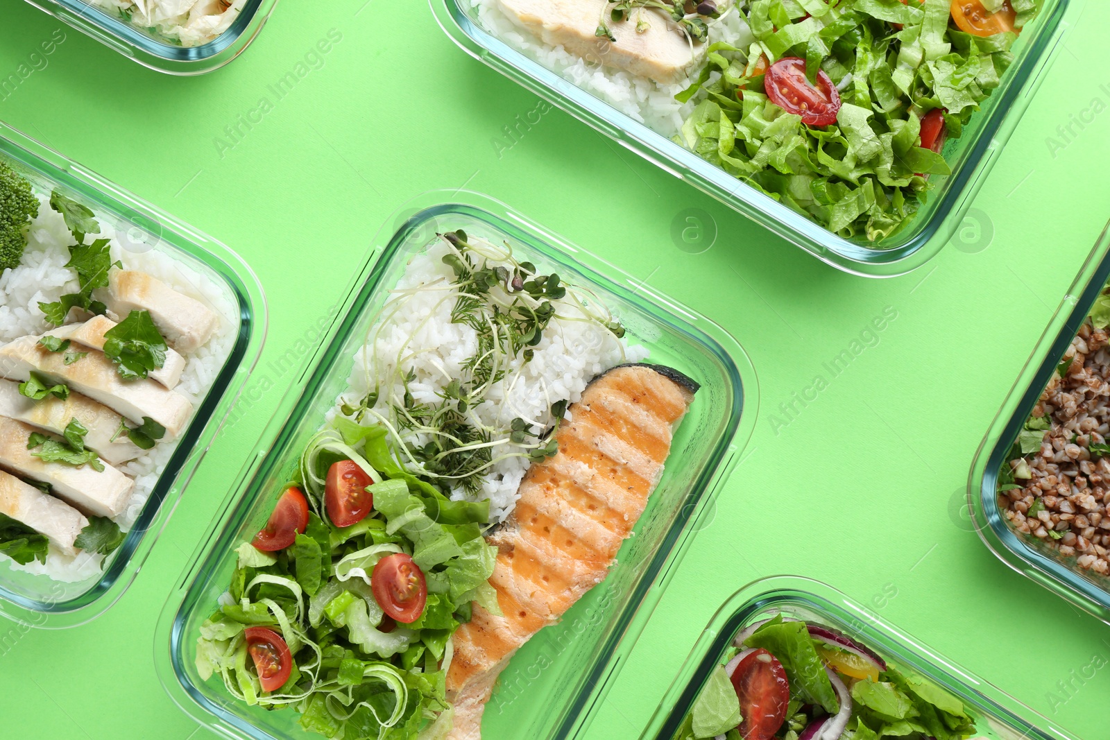 Photo of Healthy food. Different meals in glass containers on green background, flat lay