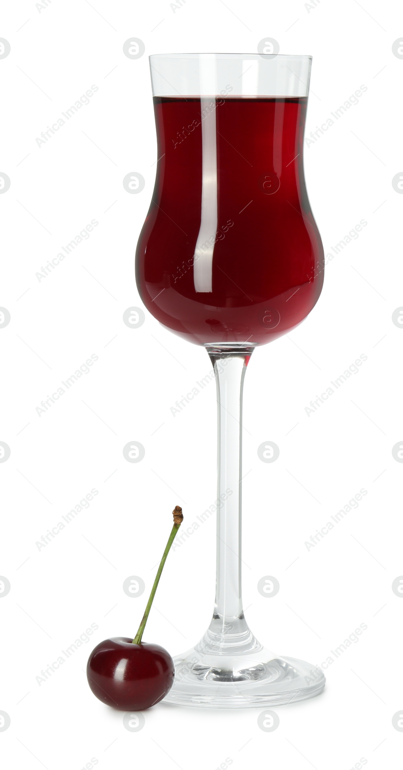 Photo of Delicious cherry liqueur in wineglass and berry isolated on white