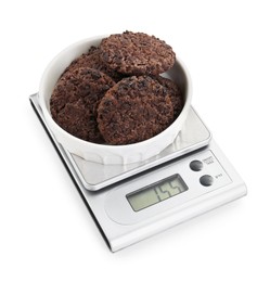 Photo of Kitchen scale with bowl of chocolate cookies isolated on white