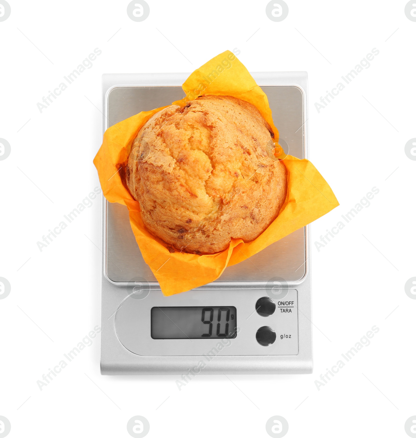 Photo of Kitchen scale with muffin isolated on white, top view