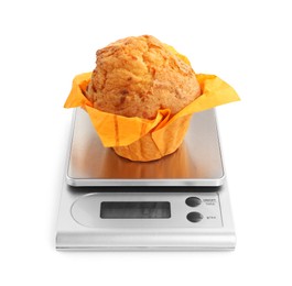 Photo of Kitchen scale with muffin isolated on white