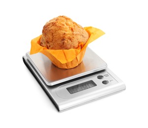 Photo of Kitchen scale with muffin isolated on white