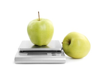 Kitchen scale with apples isolated on white