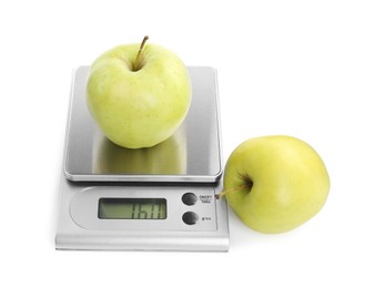 Photo of Kitchen scale with apples isolated on white