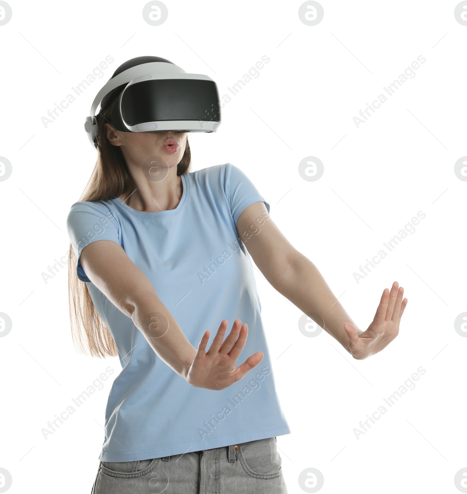 Photo of Surprised woman using virtual reality headset on white background