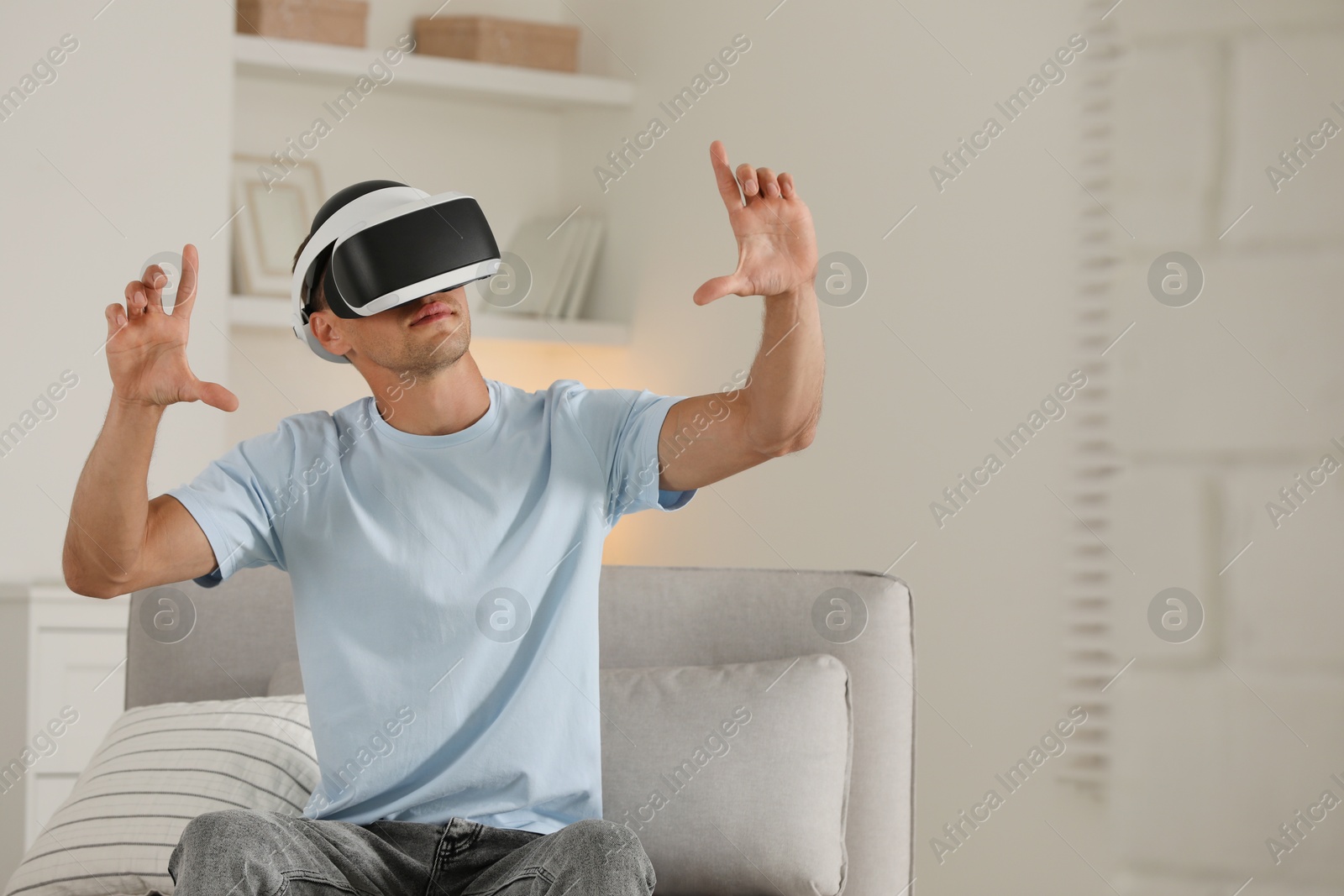 Photo of Man using virtual reality headset at home