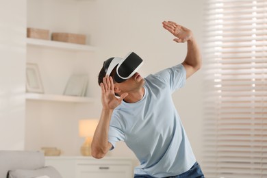 Photo of Man using virtual reality headset at home