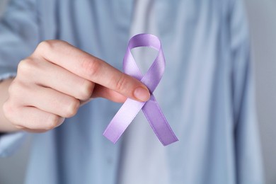 Woman with violet awareness ribbon, closeup view