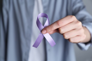 Photo of Woman with violet awareness ribbon, closeup view