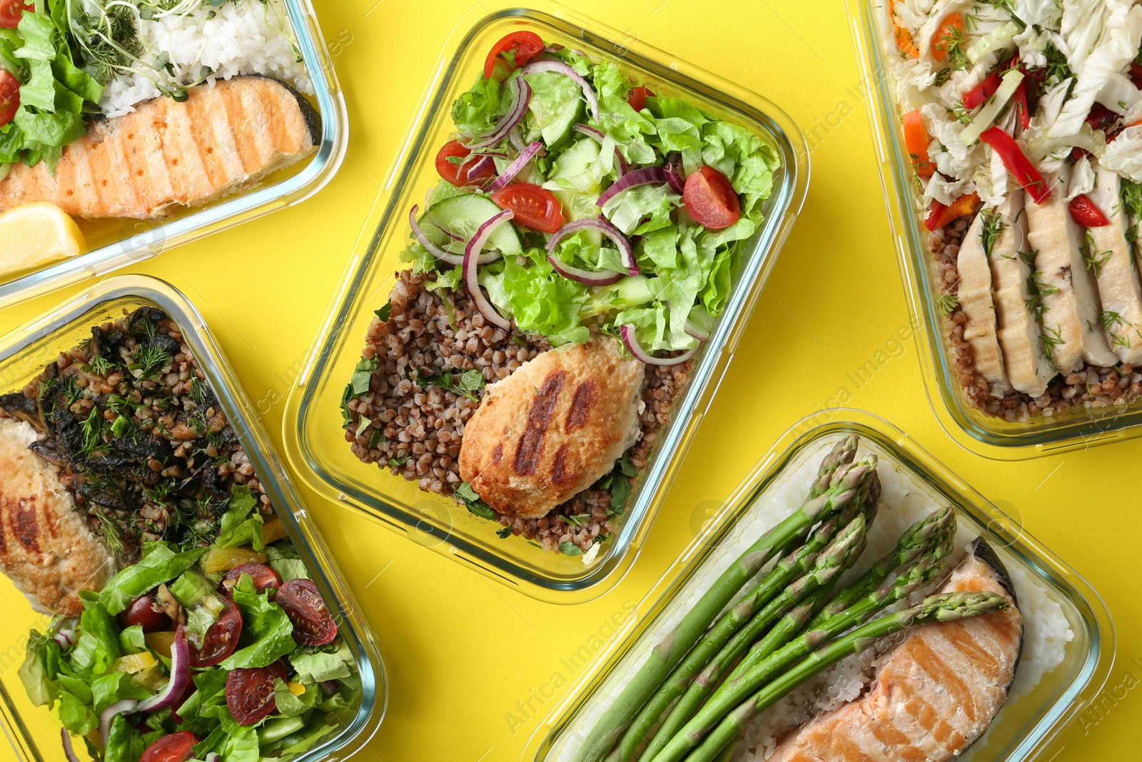 Photo of Healthy food. Different meals in glass containers on yellow background, flat lay