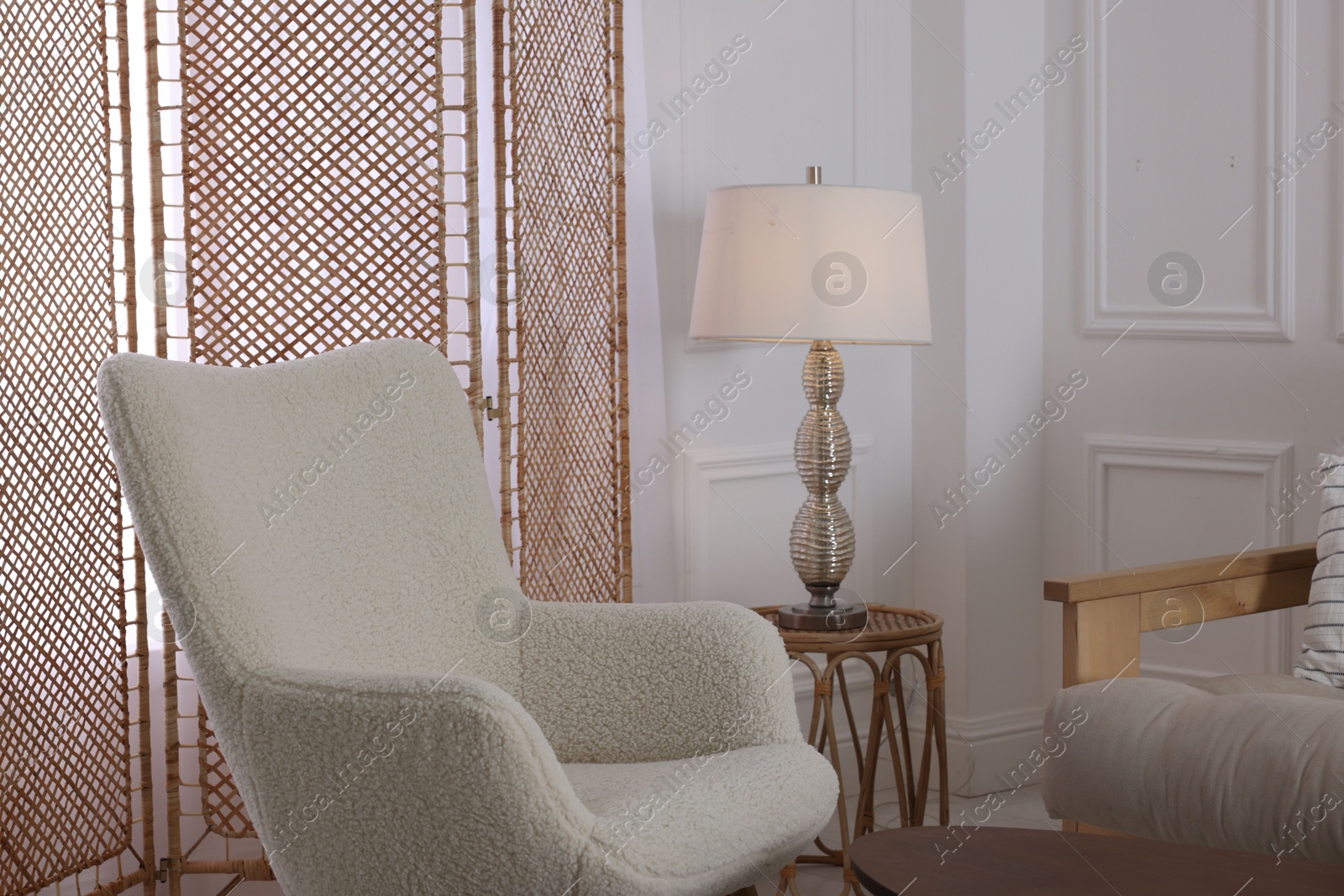 Photo of Folding screen, armchair and lamp in room