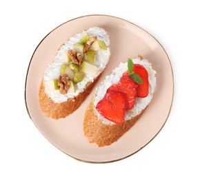 Photo of Delicious ricotta bruschettas with pear, strawberry and walnut isolated on white, top view