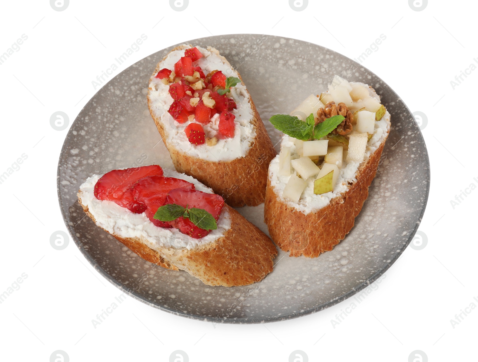 Photo of Delicious ricotta bruschettas with pear, strawberry and walnut isolated on white