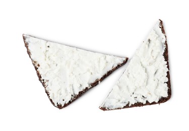 Delicious fresh ricotta (cream cheese) on pieces of bread isolated on white, top view