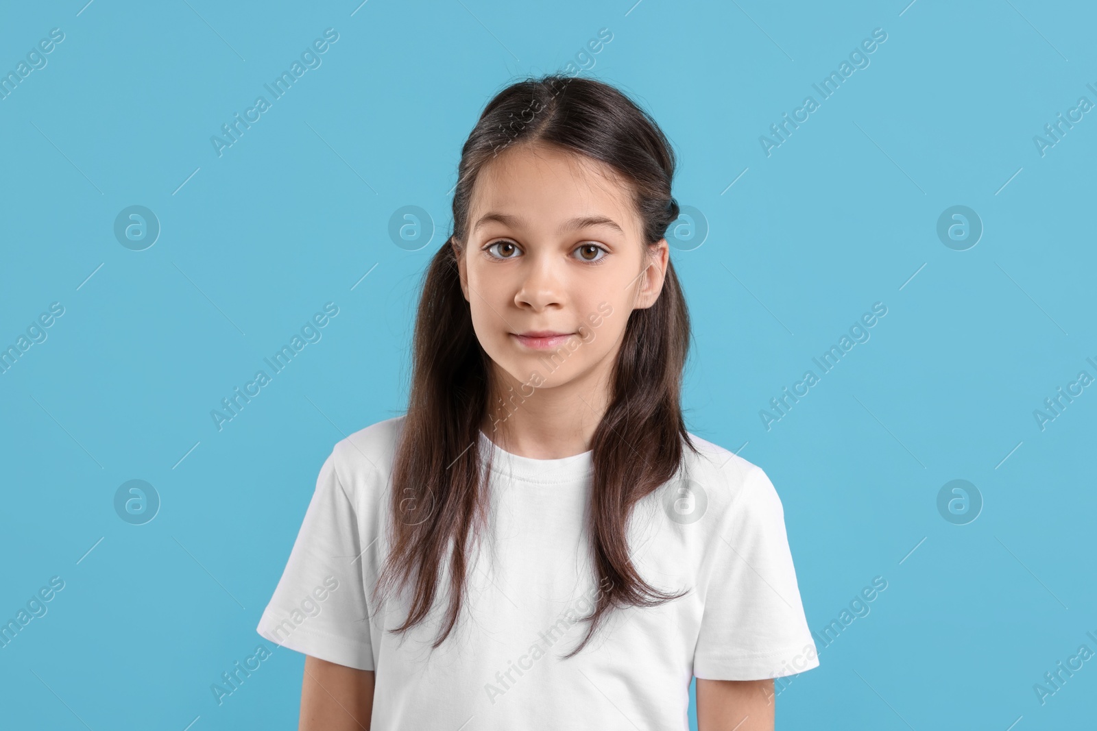 Photo of Portrait of beautiful girl on light blue background