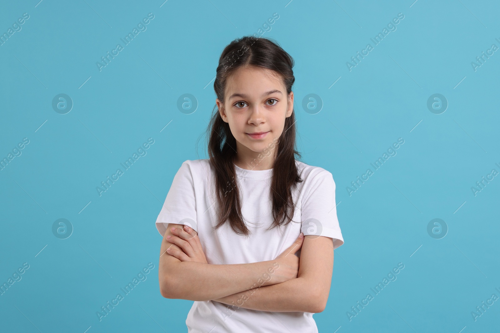 Photo of Portrait of beautiful girl on light blue background