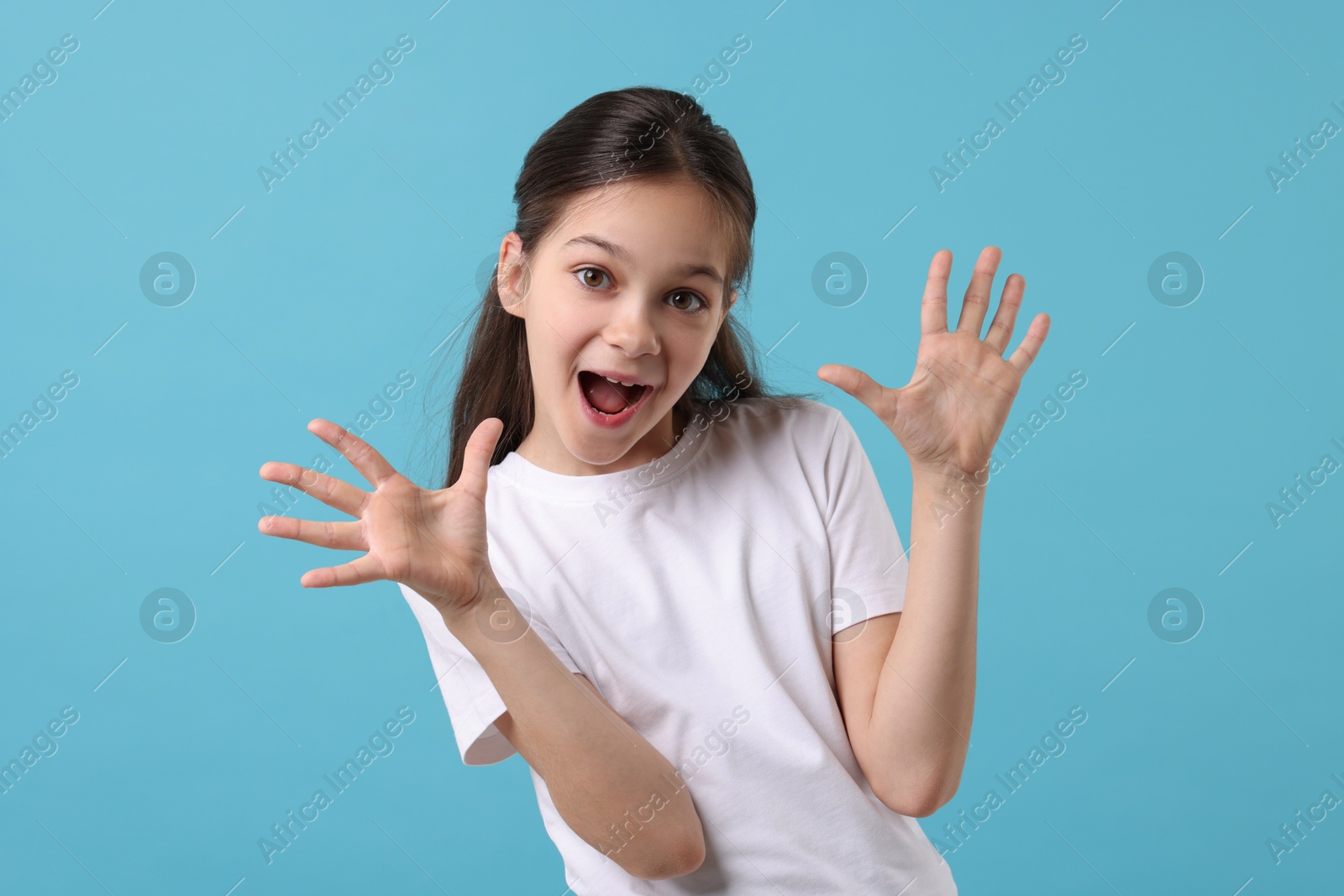 Photo of Portrait of emotional girl on light blue background