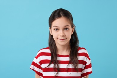 Photo of Portrait of beautiful girl on light blue background