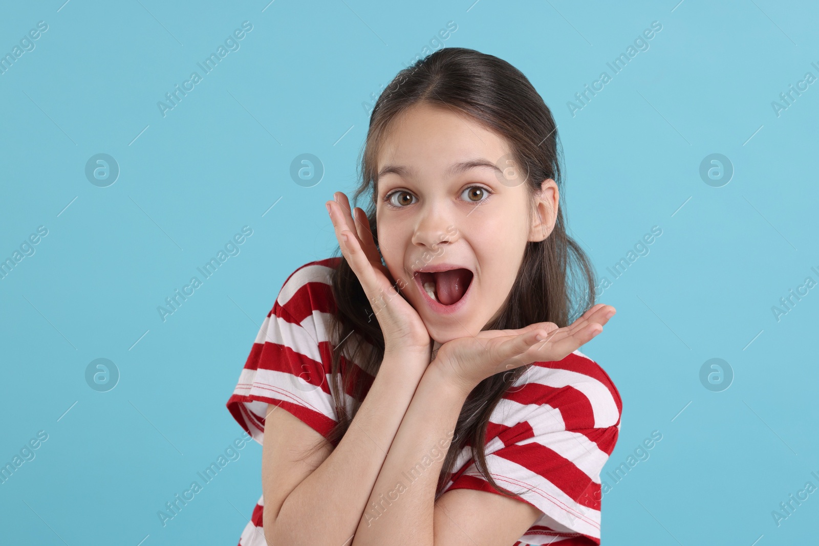 Photo of Portrait of emotional girl on light blue background