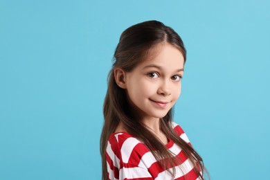 Portrait of beautiful girl on light blue background