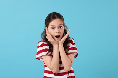 Photo of Portrait of emotional girl on light blue background