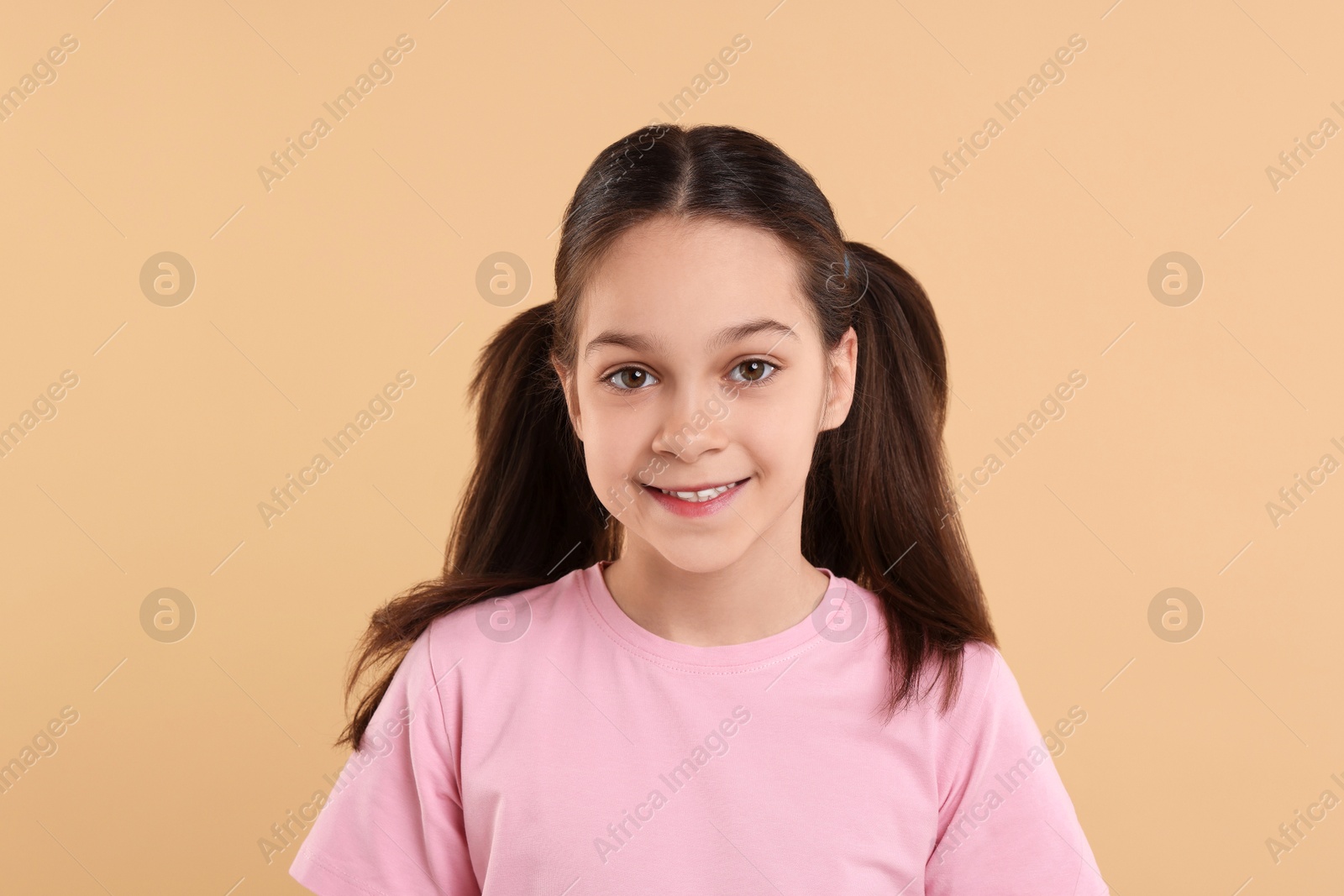 Photo of Portrait of beautiful girl on beige background