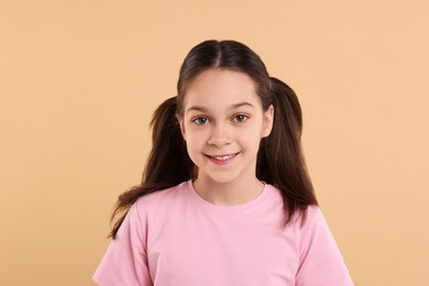 Portrait of beautiful girl on beige background