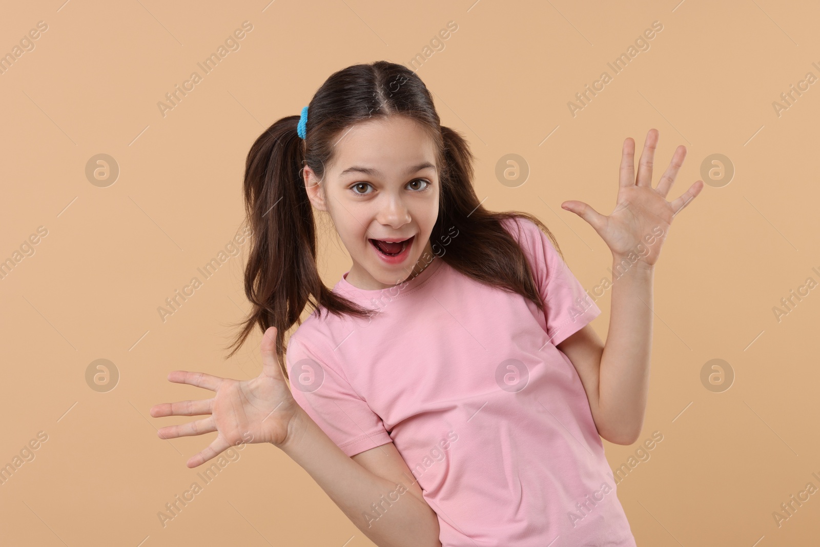 Photo of Portrait of emotional girl on beige background