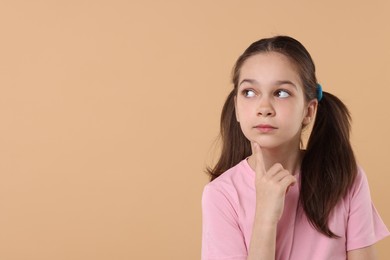 Photo of Portrait of beautiful girl on beige background, space for text