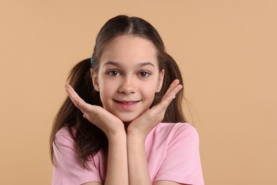 Portrait of beautiful girl on beige background