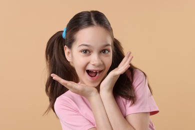 Photo of Portrait of emotional girl on beige background