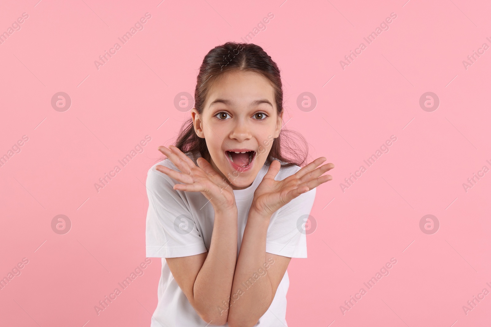 Photo of Portrait of emotional girl on pink background