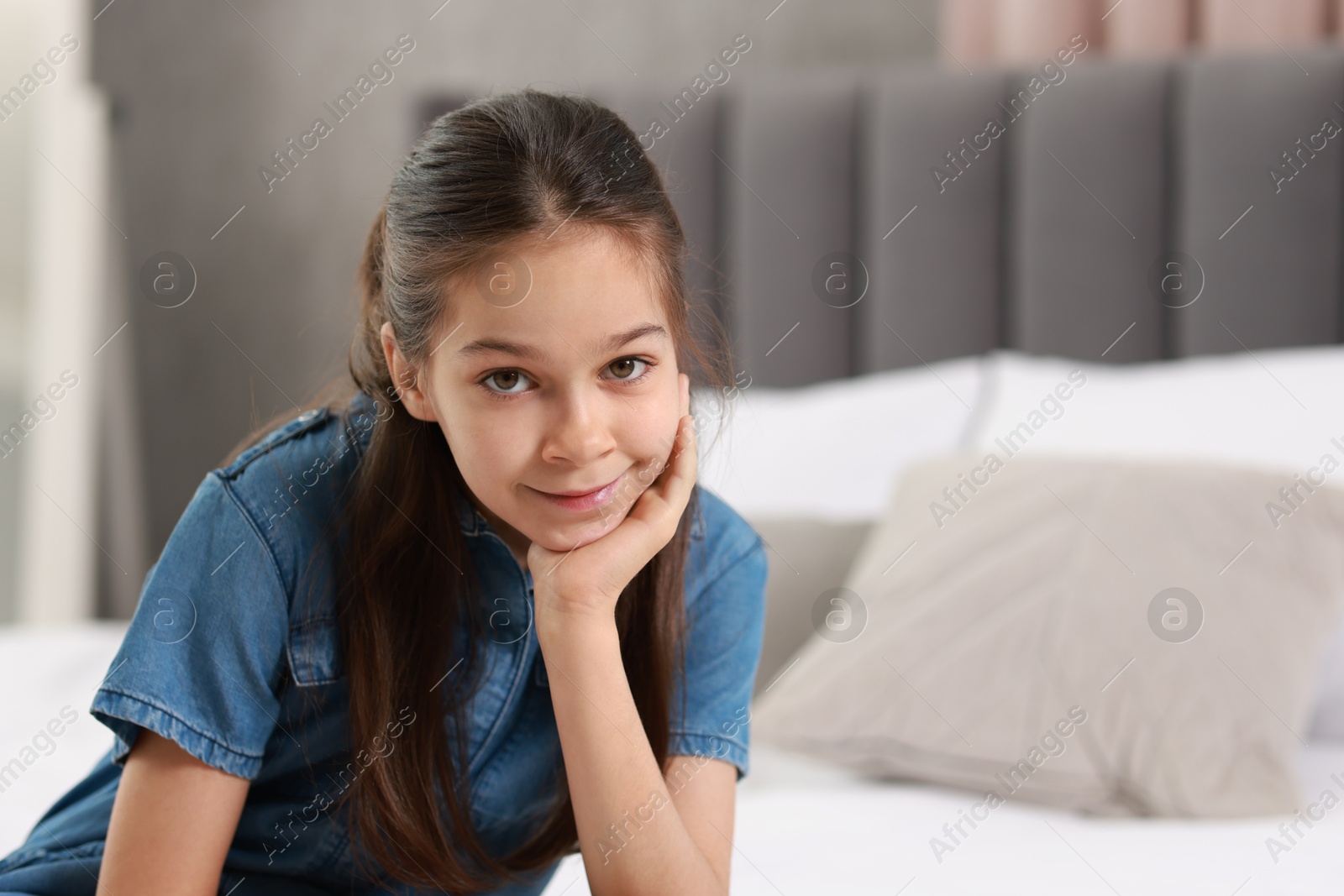 Photo of Portrait of cute little girl indoors, space for text