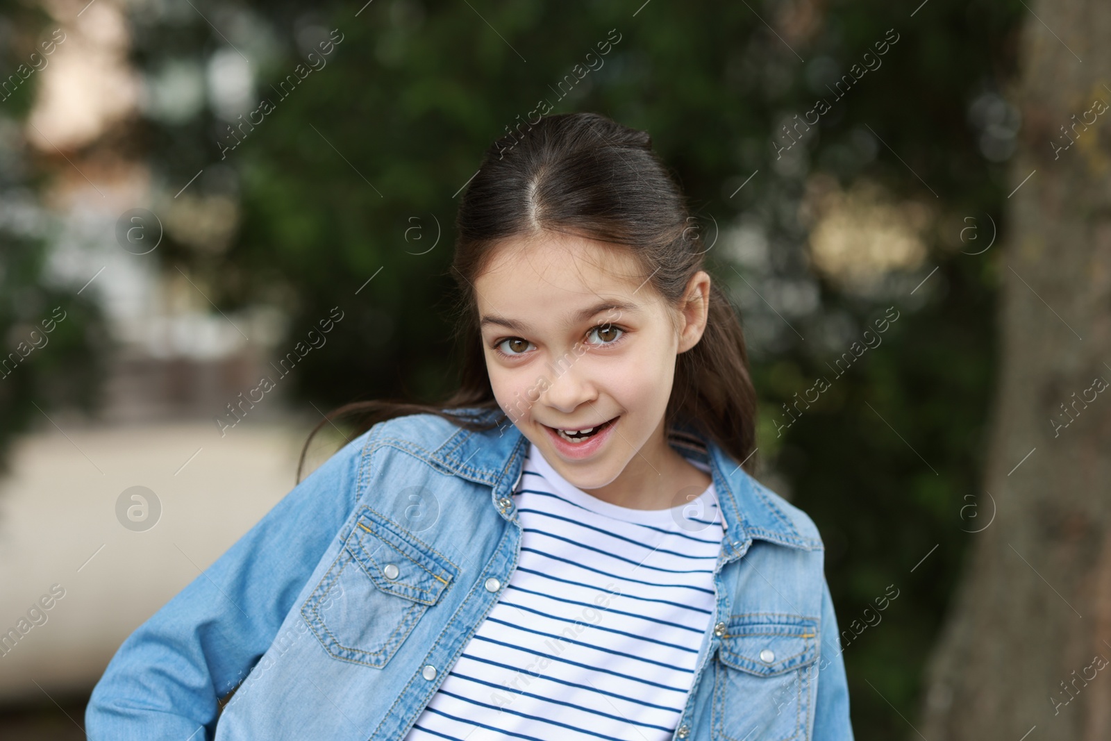 Photo of Portrait of happy little girl outdoors. Cute child