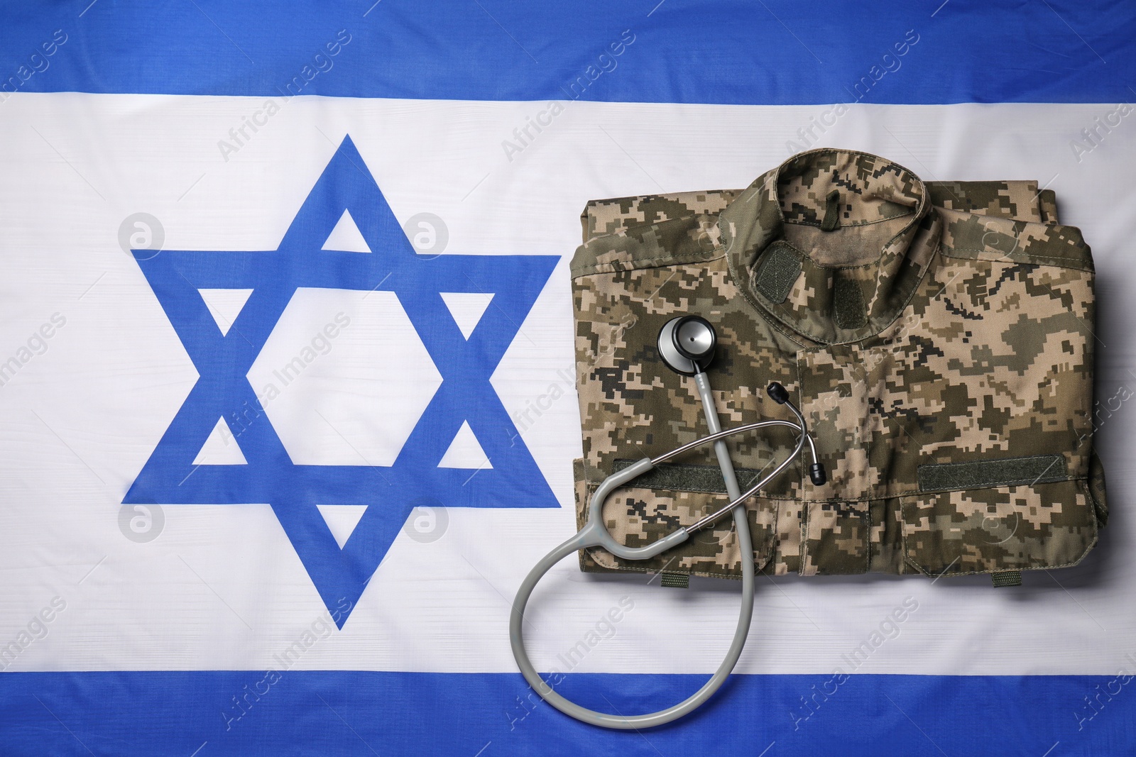 Photo of Stethoscope and military uniform on flag of Israel, top view