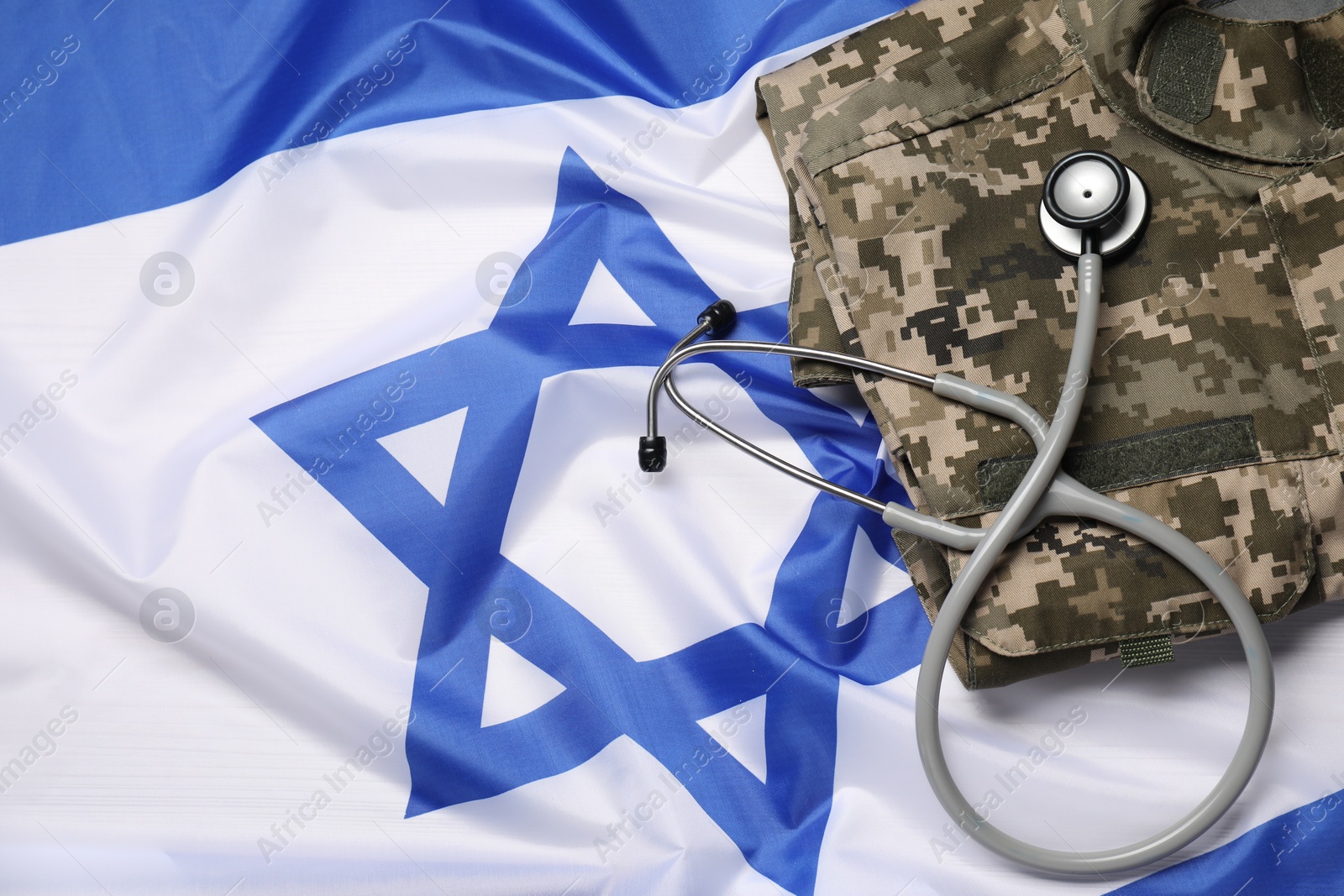 Photo of Stethoscope and military uniform on flag of Israel, above view